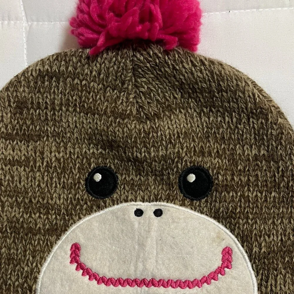 Adorable brown and pink winter monkey hat with pink pom poms